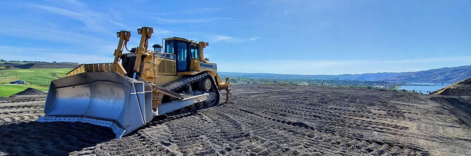 A tracked dozer on a bench above the Snake River valley