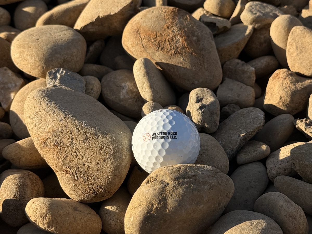 Rounded river rock cobble with a golf ball for scale