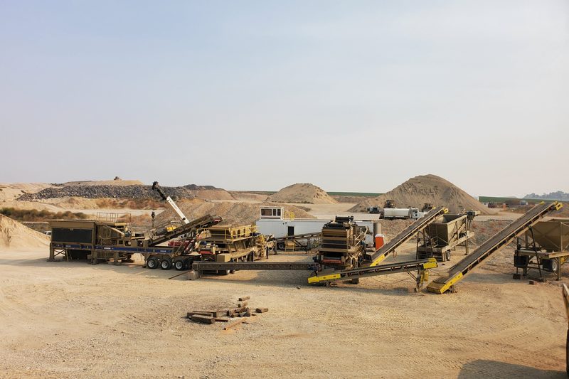 A crushing plant and stockpiles on an open pit floor